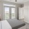 a bedroom with a bed and a fan