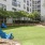 a lawn with chairs and trees in front of a building